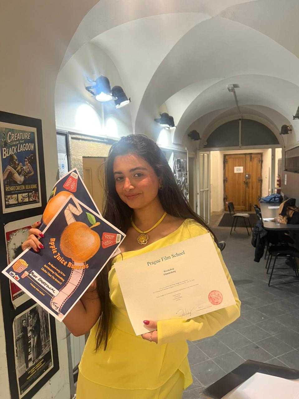 Tracy Greige holding her Prague Film School certificate and audience award