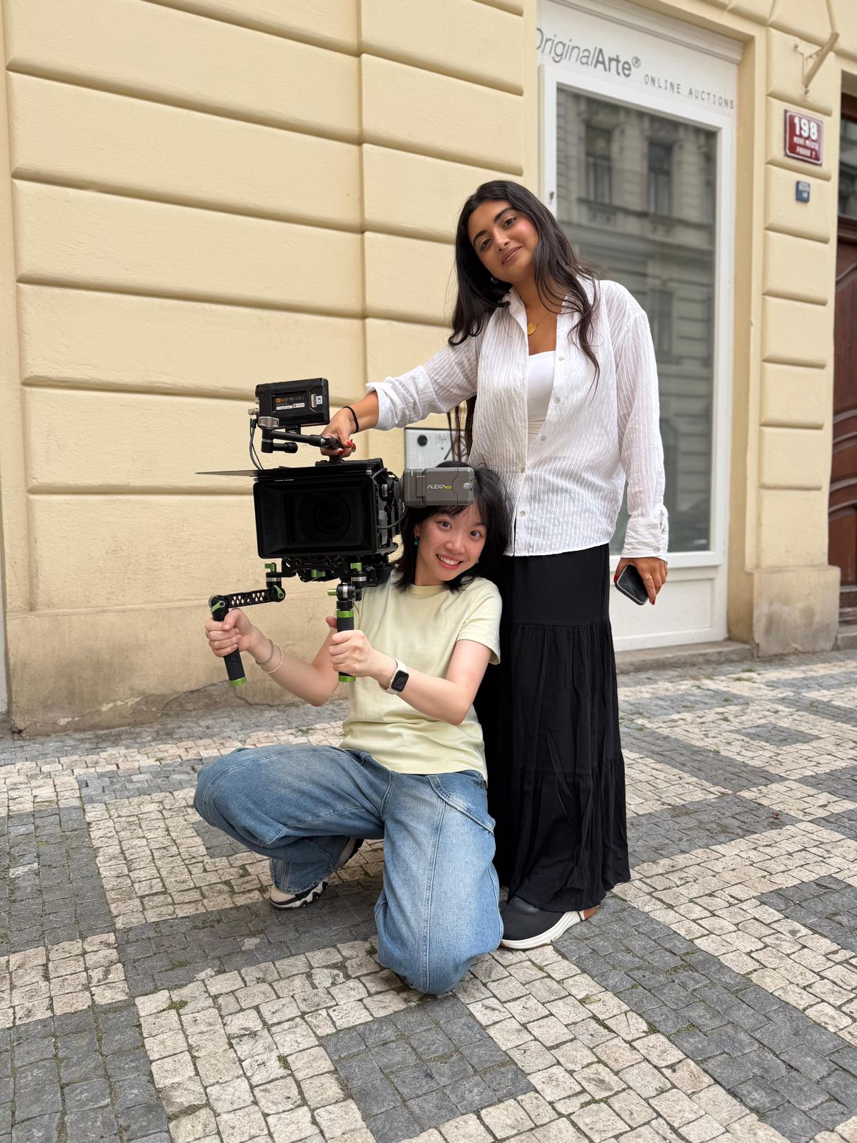 Tracy Greige and a collaborator setting a cinema camera in Prague