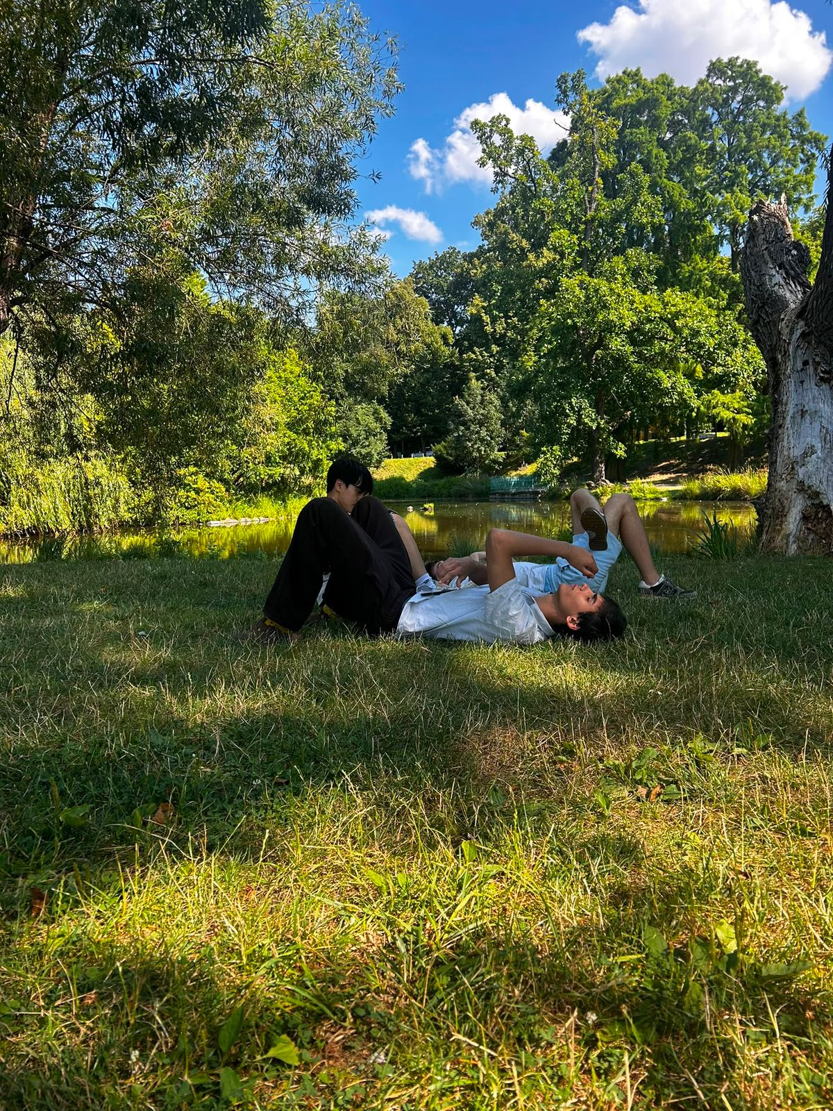 Prague film crew resting beside a pond between takes