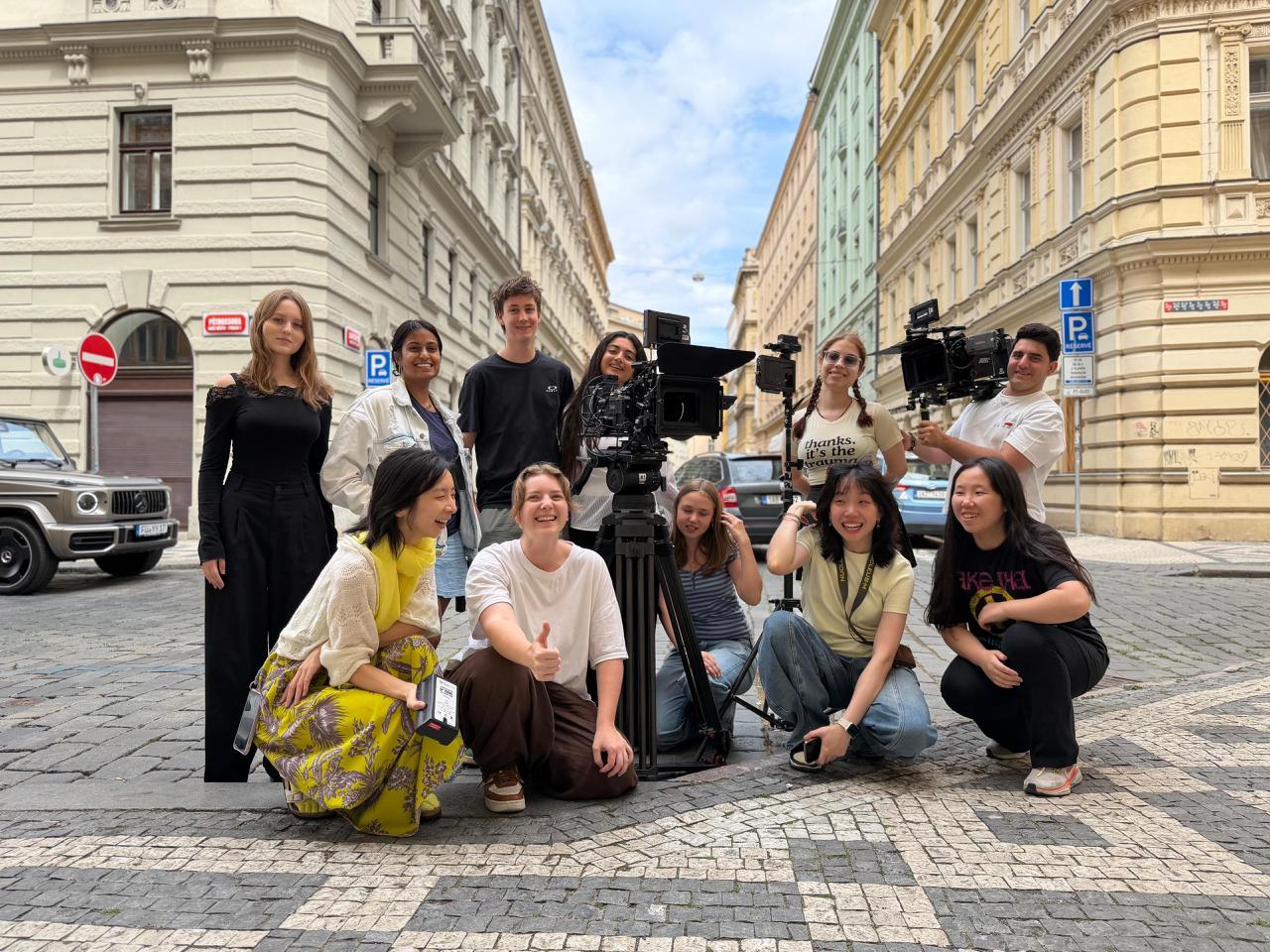 Prague Film School crew gathered around camera equipment