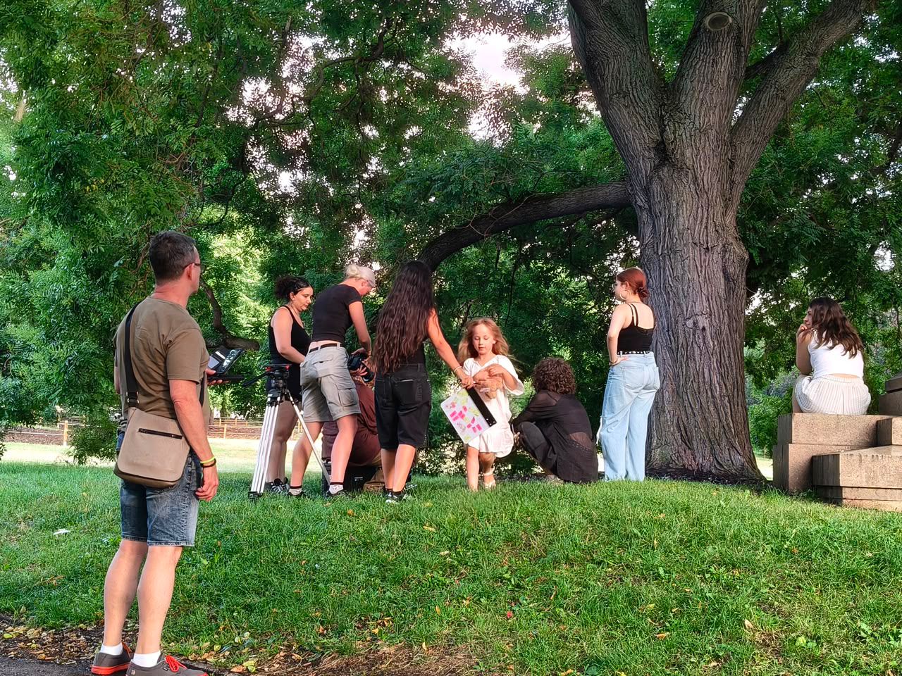 The Soi film crew working under a tree in a park
